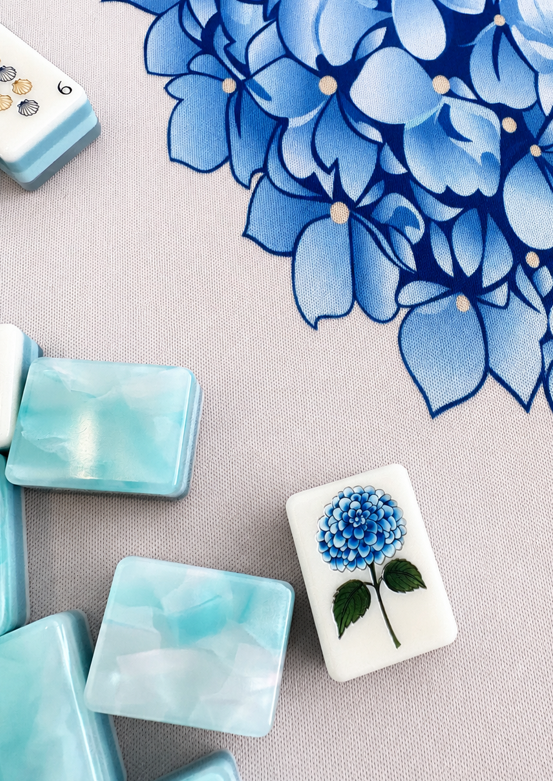 Coastal Tile Society hydrangea flower tile and marbled aqua tile backs on the Newport mat